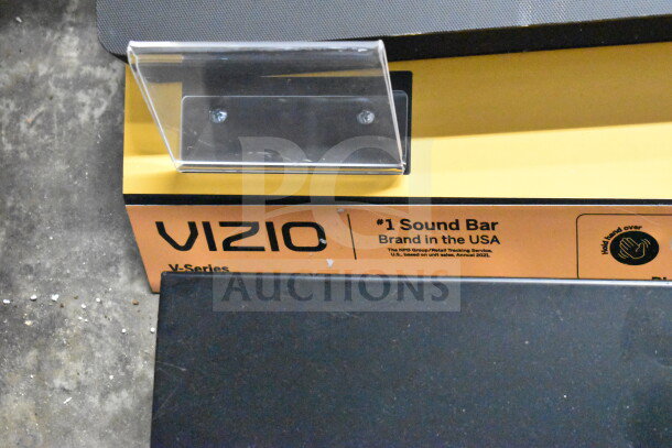 Vizio V-Series sound bar display with branding, noted as #1 sound bar in USA. Includes LG soundbar and speakers, store demo.