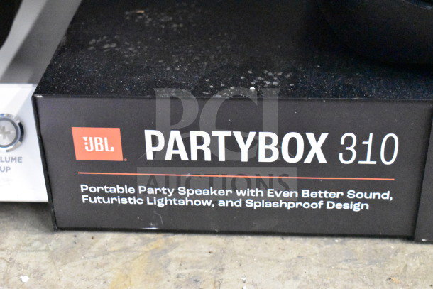 JBL Partybox 310 store display, highlighting portable party speaker with enhanced sound, lightshow, splashproof design.