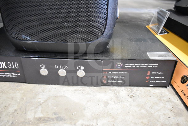 Store display featuring JBL Partybox 310 speaker. Highlights include JBL Pro Sound, light show, mic/guitar inputs, IPX4 splashproof.