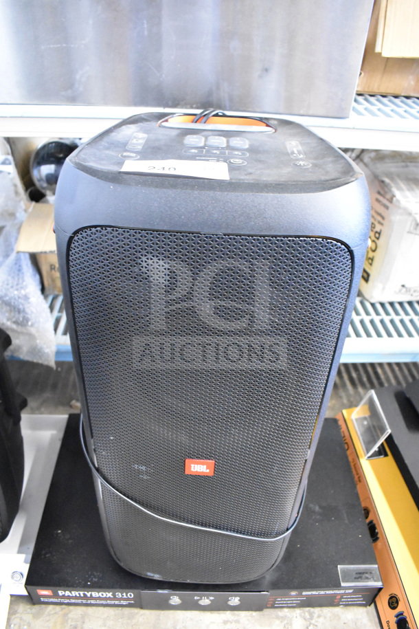 Store display featuring a JBL Partybox 310 speaker with control panel. Speaker in good used condition.