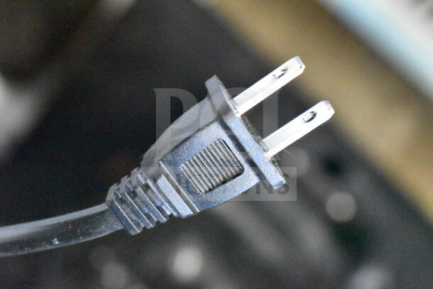 Close-up of a standard two-pin power plug, unclear if related to JBL Partybox 310 display condition.