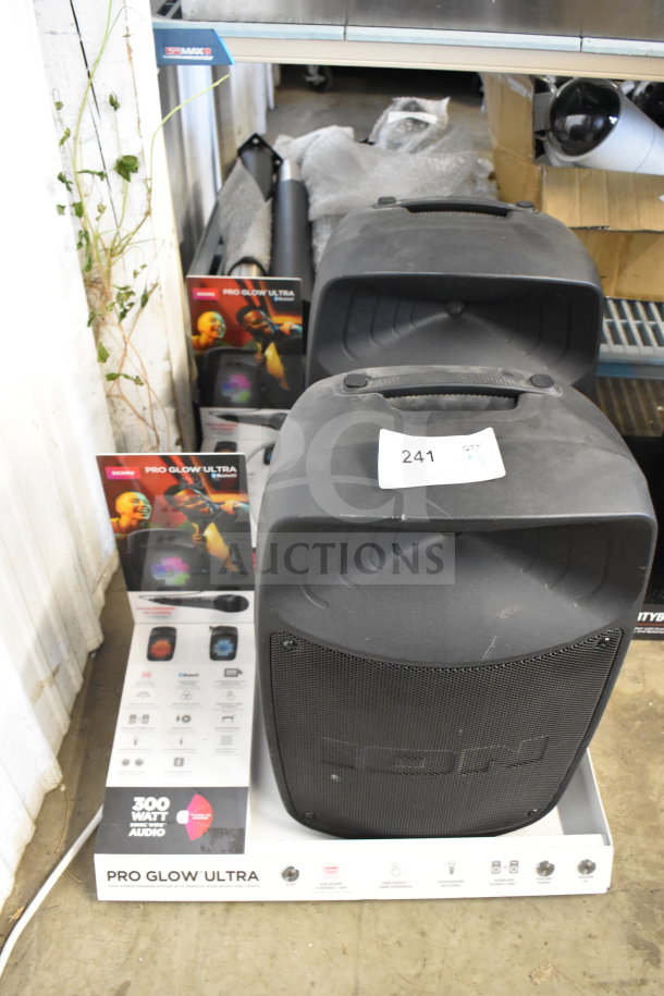 2 Ion Pro Glow Ultra speakers on store display, 300W audio, in good condition, with promotional stand and tag labeled "241 qty x2."