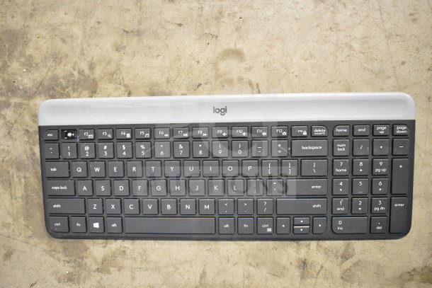 Logitech keyboard, full-size with numeric keypad, black keys, gray trim, good condition, ideal for office use.