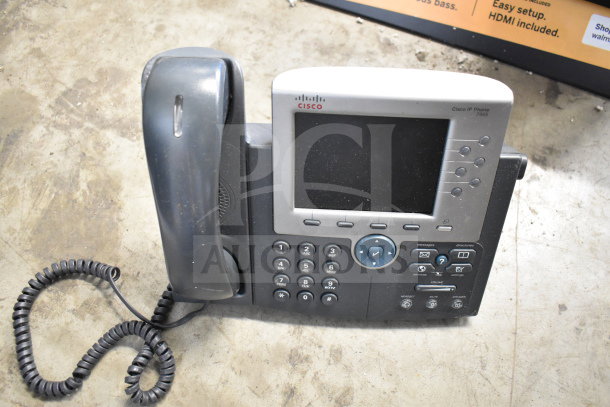 Cisco IP Phone 7965, corded, used condition. Features include a display screen, keypad, and function buttons.