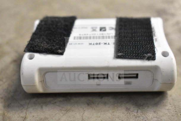 White device with two USB ports, adhesive strips, and visible model: TK-307K. Part of a mixed office electronics lot.