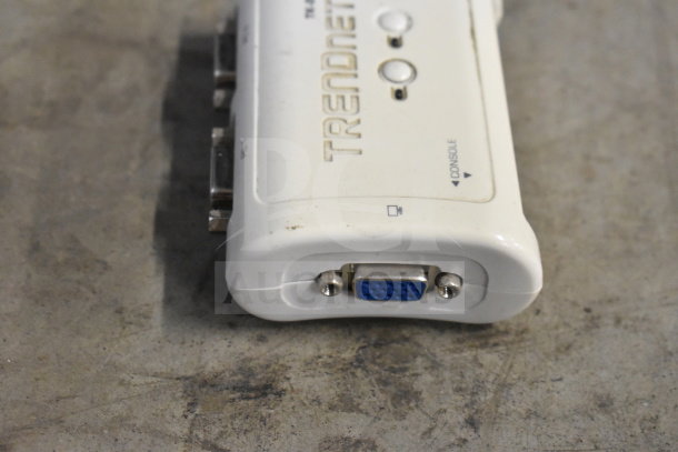 TRENDnet console switch with visible laptop and console ports, white casing, slight wear visible.