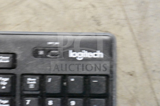 Logitech corded keyboard, used; part of a lot including office telephones and a credit card reader.