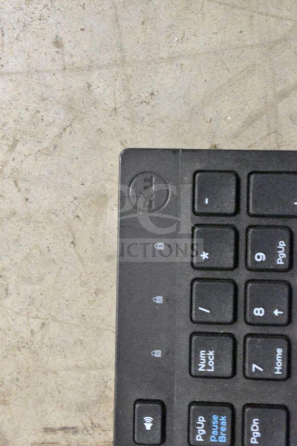Dell keyboard, visible number pad, used condition; part of auction lot including telephones and credit card reader.