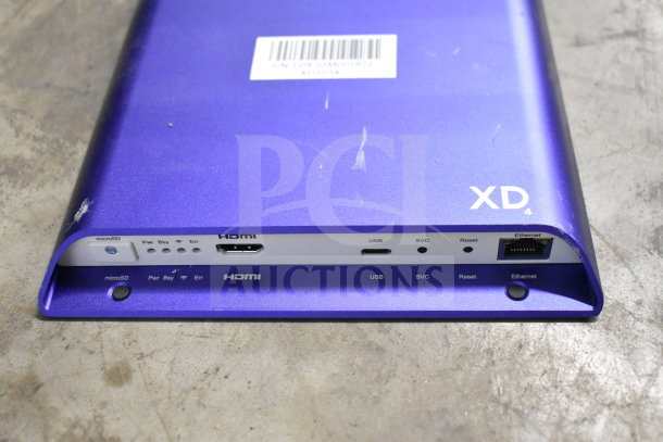Purple XD4 electronic device, minor scratches, ports for microSD, HDMI, USB, SVC, Ethernet, barcode label visible.