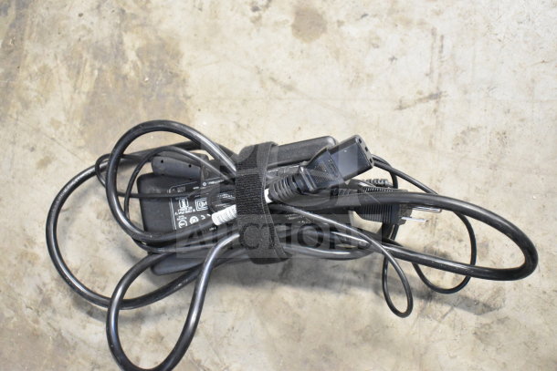 Lot of assorted cords tied with a velcro strap, items include office phone cables. Condition appears used.