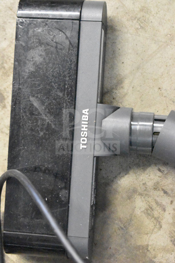 Toshiba office device with visible wear, part of a lot including corded phones, keyboard, and credit card reader.