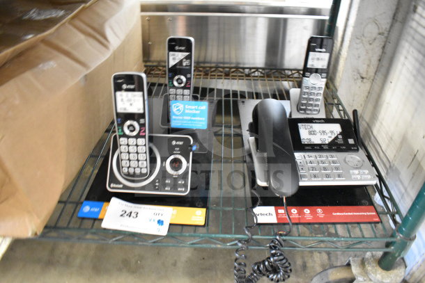 Store display featuring AT&T and VTech cordless telephones, with digital screens, keypads, and labels indicating smart call features.