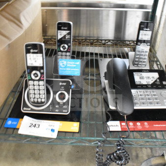Store display featuring AT&T and VTech cordless telephones, with digital screens, keypads, and labels indicating smart call features.