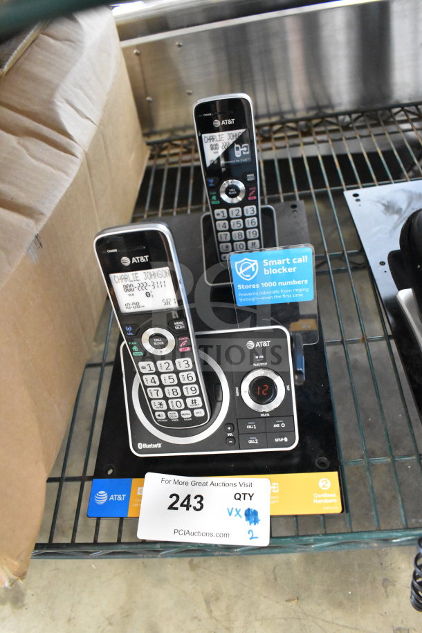 AT&T store display with two cordless phones featuring smart call blocker. Includes labels and promotional tag.