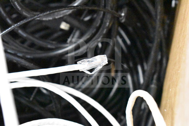Lot of various black and white cables, including Ethernet cables, in a mixed bundle. Condition appears used.
