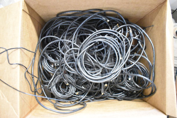 Box of assorted black cables, various types and lengths, as a bulk lot. Good condition, suitable for electronics and repairs.