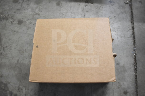 Closed cardboard box on a concrete floor, containing a computer mouse, keyboard, and cables. No visible labels or markings.