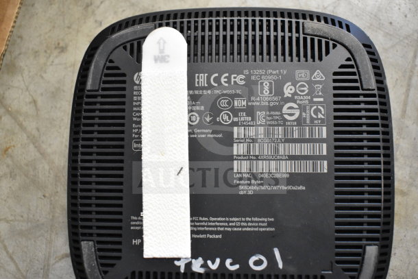 Close-up image of the bottom of an HP device showing various certification labels, model number 4XR59UC#ABA, and serial number 8CG0172JLY.