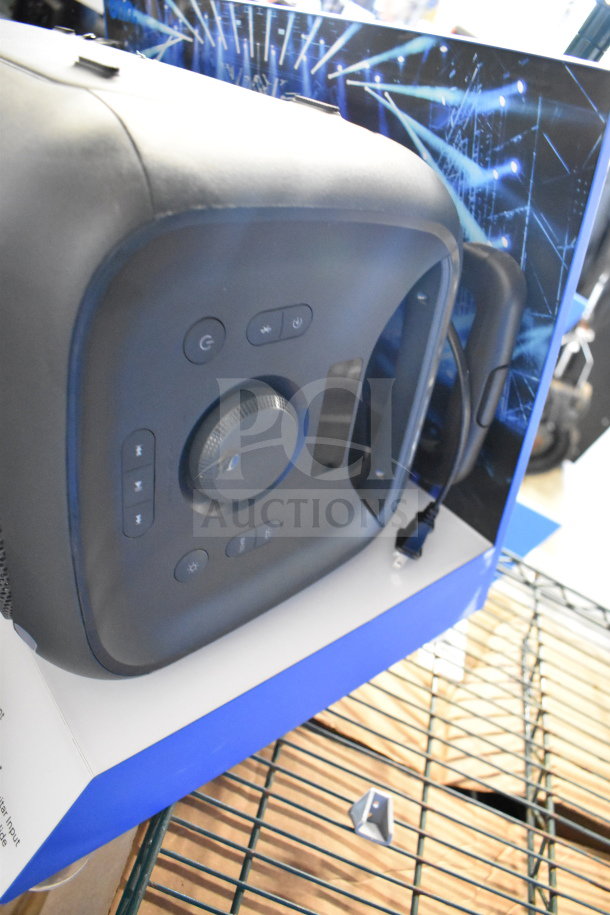 Onn speaker on store display, featuring control buttons and volume dial. Includes 2 Samsung speakers. Condition appears new.