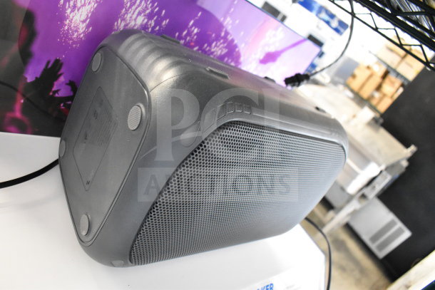 Onn speaker on display, featuring a black plastic casing and mesh front. Minimal wear, suitable for indoor use.