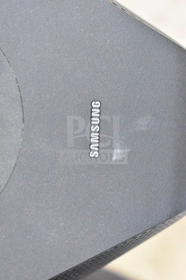 Set of speakers including 2 Samsung and 1 Onn model. Features store display units. Visible Samsung branding.