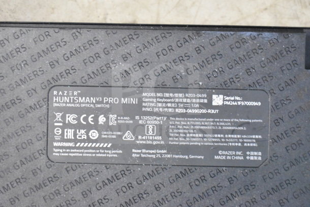Razer Huntsman V3 Pro Mini gaming keyboard label showing model RZ03-0499, serial PM2441F97000949, and manufacturer details.