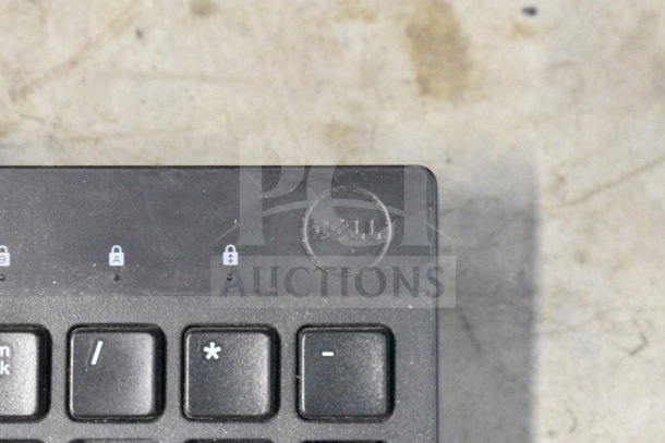 Dell keyboard close-up showing logo and lock indicators; part of 20-item auction including tech accessories.