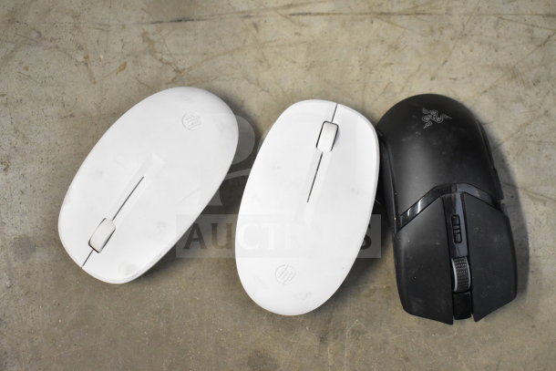 Assorted items include two white HP computer mice and a black Razer gaming mouse. Visible wear on surfaces.