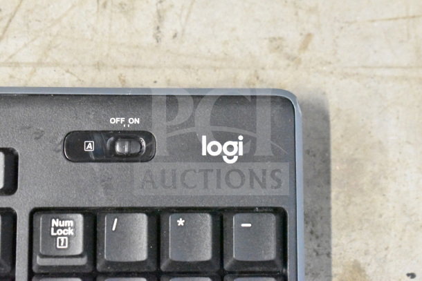 Logitech keyboard, black, power switch labeled "ON/OFF," condition appears used. Part of 20-item tech auction bundle.