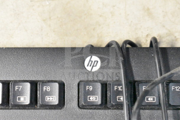 HP keyboard with visible logo, keys F7-F12, and multiple cables. Part of 20-item tech lot including keyboards, mice, and router.