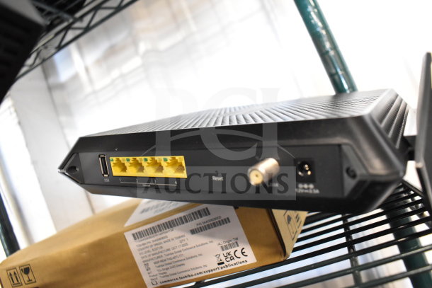 Netgear router with four Ethernet ports and USB input, in good condition. Visible power connection and reset button.