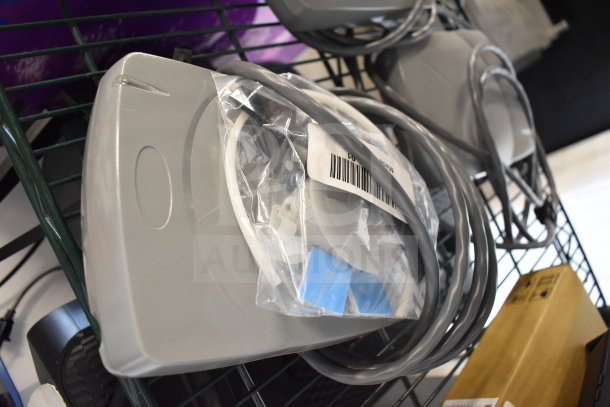 Assorted electronics including keyboards, computer mice, and a Netgear router; items are in various conditions with cables and packaging visible.