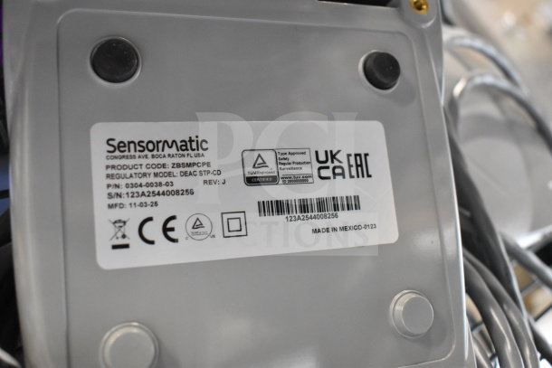 Label on a Sensormatic device, showing product code ZBSMPCPE, model DEAC STP-CD, and serial number 123A2544008256.
