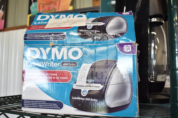 Dymo LabelWriter 450 Turbo in worn packaging, visible label maker image. Printer offers high-speed label and barcode printing.