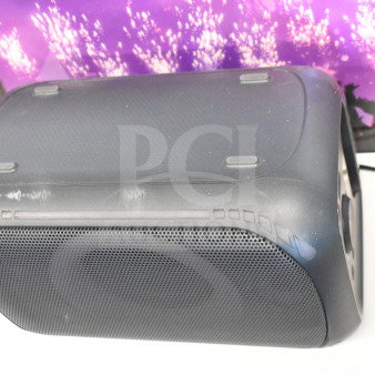 Onn Medium Party Speaker, black with visible wear, on display. Features built-in handle, mesh grille, and wired connection.