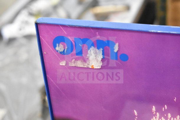 Corroded corner of an Onn display panel, purple with worn print.