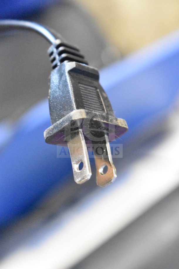 Power cord plug for Onn Medium Party Speaker, close-up view.