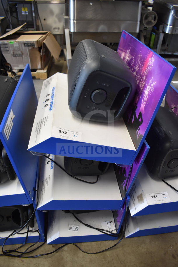 Store display with multiple Onn Medium Party Speakers, black, showing controls and dials. Includes quantity label tags.