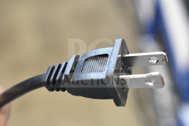 Close-up of a black two-prong power plug, part of the Onn Medium Party Speaker display.