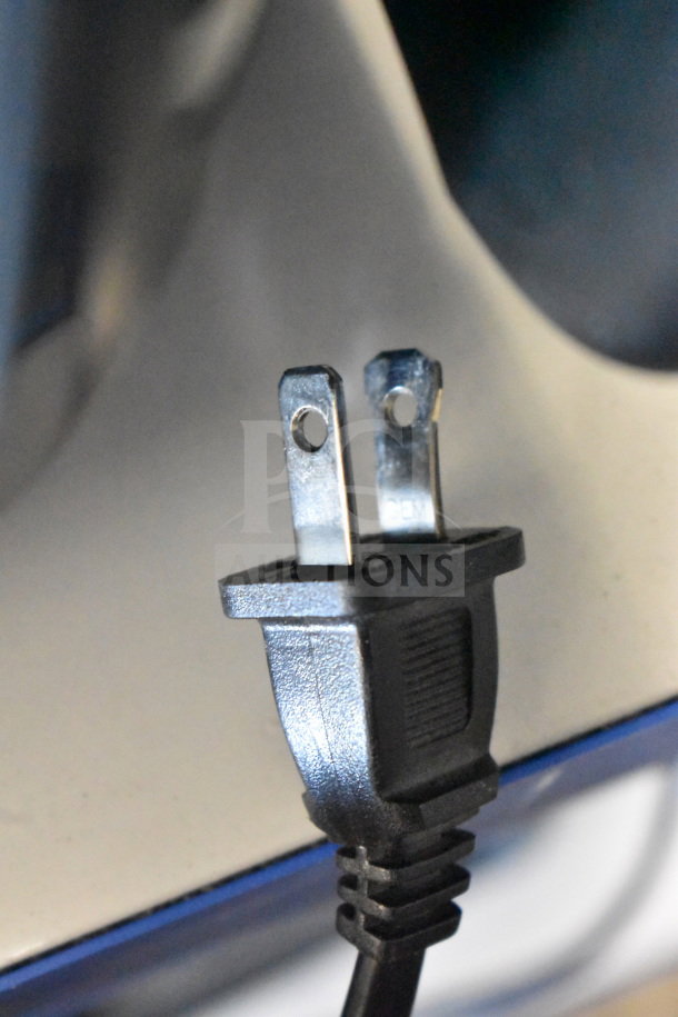Close-up of a power plug, likely for the Onn Large Party Speaker, showing detailed prongs and a portion of the black cord.