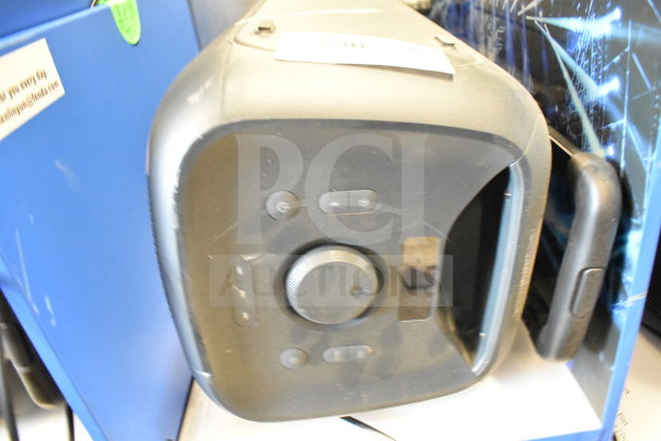 Onn Large Party Speaker on store display, black finish, control panel with volume knob and power button, minor wear visible.