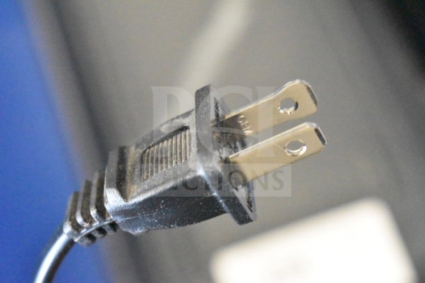 Close-up of a two-prong power plug for an Onn Large Party Speaker. Visible "110" marking on the plug.