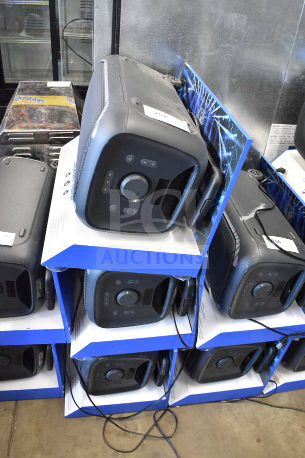 Stack of Onn large party speakers in store display, showcasing six units. Each speaker has control panel and appears in good condition.