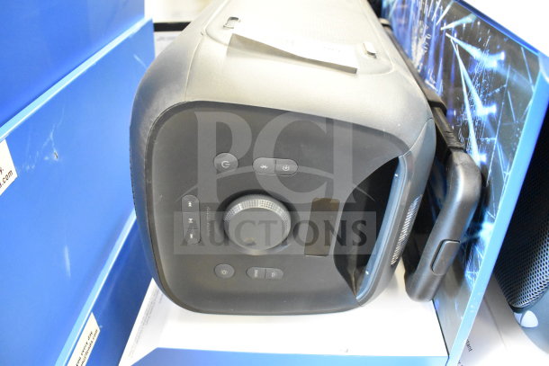 Onn large party speaker on display stand, featuring control buttons and sleek design. Good condition.