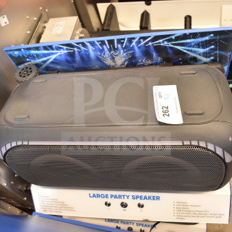 Store display with Onn Large Party Speaker featuring Bluetooth, 12-hour playback, and multicolor LED lights. Auction tag visible.