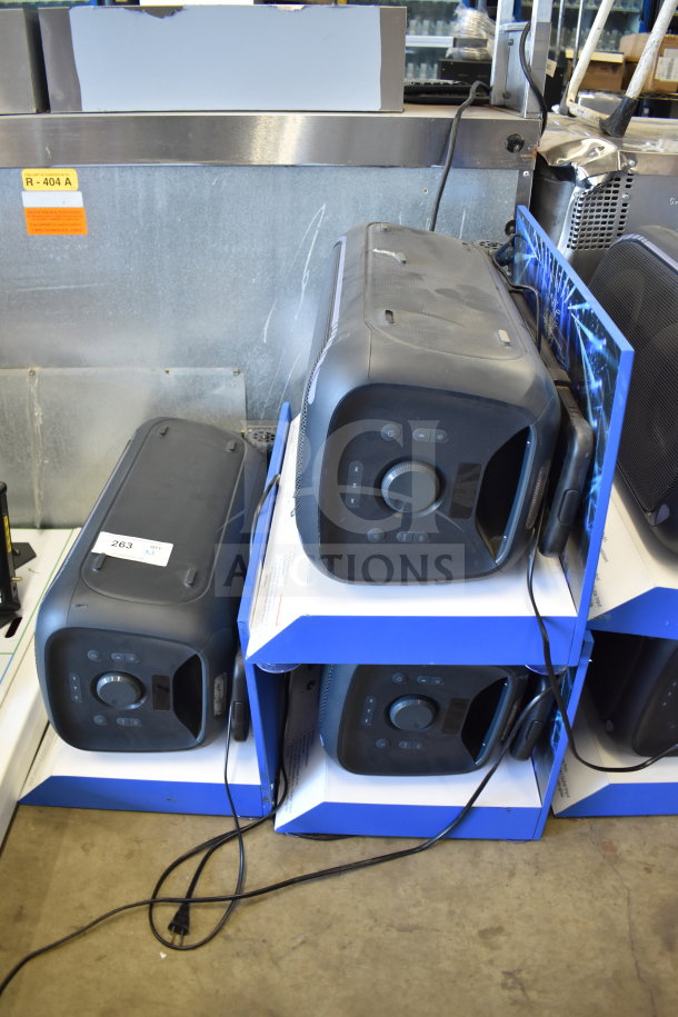 Three Onn Large Party Speakers on store display, gently used with cords visible. Ideal for high-volume audio events.