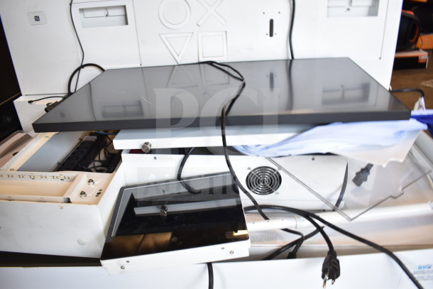 Store display setup featuring a monitor with black screen, several cables, and a fan unit. Condition appears used.