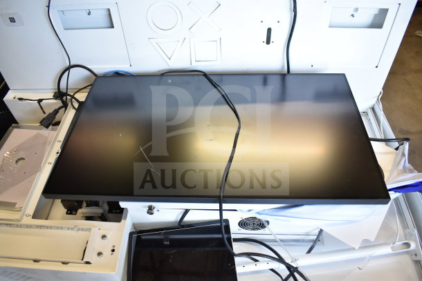 Store display with monitor and cables, white casing, mildly scratched screen, multimedia setup, ideal for electronics showcase.