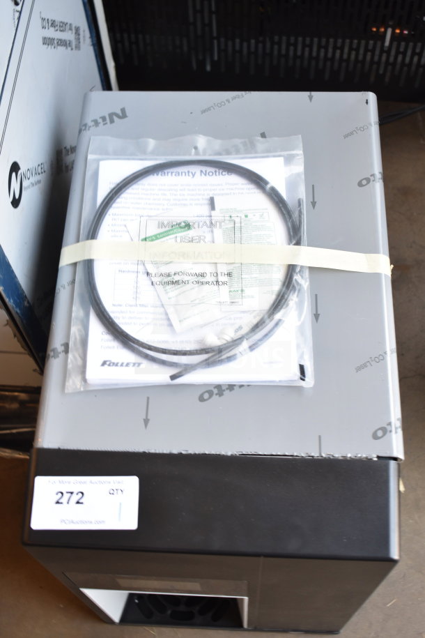 Brand new Follett 15CI114A-IW-NF-ST-00 countertop ice maker, scratch and dent, with 15 lb bin and warranty notice.