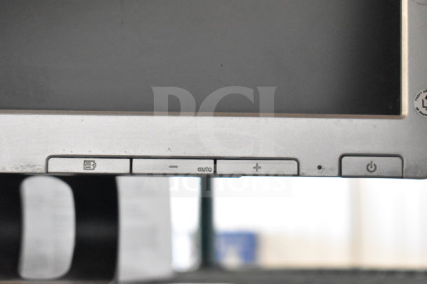 4 monitors, including Dell and HP, visible with control buttons, in used condition. Ideal for multiple setups.